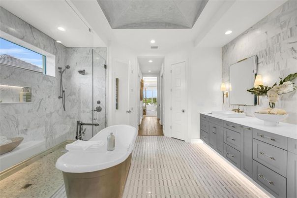 Bathroom, Dual Sink Vanities, Free Standing Baths, Glass Shower, Interior, Marble Walls, Recessed Lighting, Wood Texture Flooring