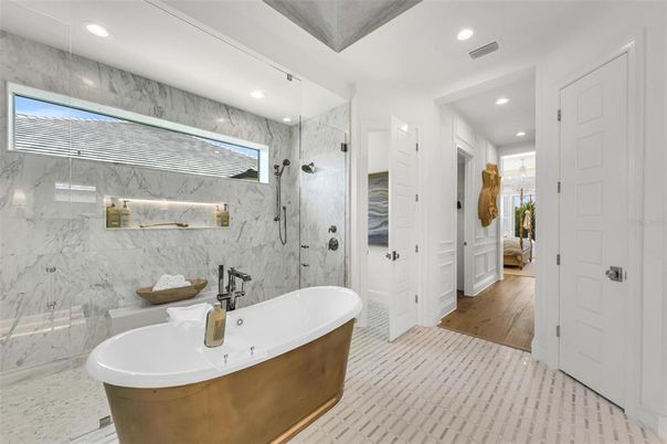 Bathroom, Free Standing Baths, Glass Shower, Interior, Marble Walls, Recessed Lighting, Wood Texture Flooring