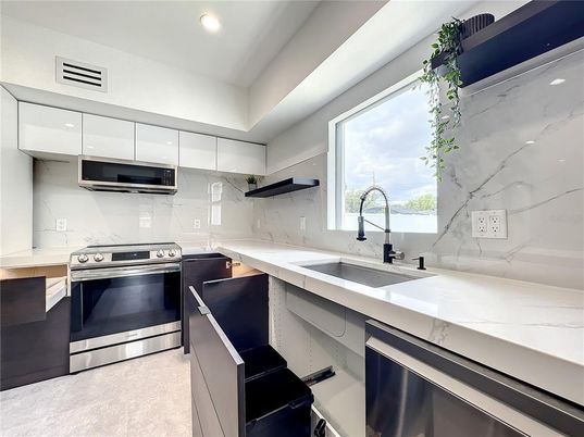 Interior, Kitchen, Marble Walls, Recessed Lighting, Stainless Steel Appliances