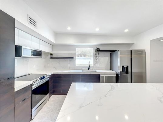 Interior, Kitchen, Marble Walls, Recessed Lighting, Stainless Steel Appliances