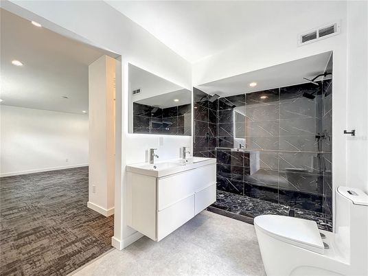 Bathroom, Dual Sink Vanities, Free Standing Baths, Glass Shower, Interior, Marble Walls, Recessed Lighting