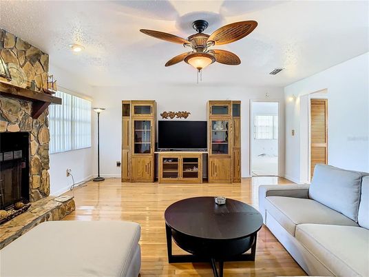 Fireplace, Interior, Living room, Recessed Lighting, Stone Walls, Wood Texture Flooring