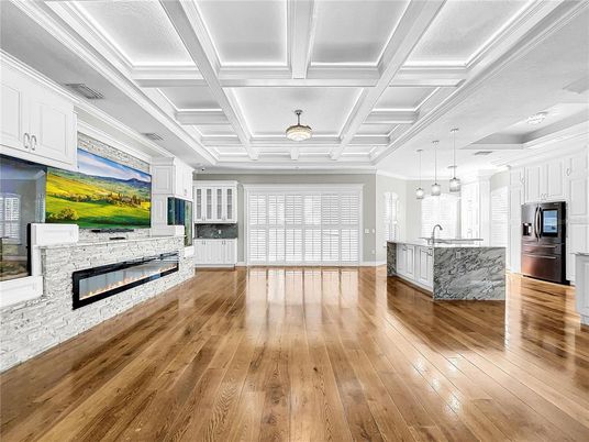 Empty room, Fireplace, Interior, Kitchen, Pendant Lights, Stainless Steel Appliances, Wood Texture Flooring