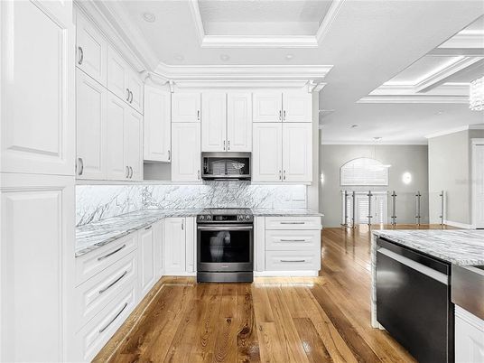 Interior, Kitchen, Marble Walls, Recessed Lighting, Stainless Steel Appliances, Wood Texture Flooring
