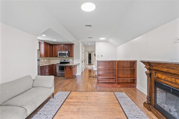 Fireplace, Interior, Kitchen, Recessed Lighting, Stainless Steel Appliances, Wood Texture Flooring