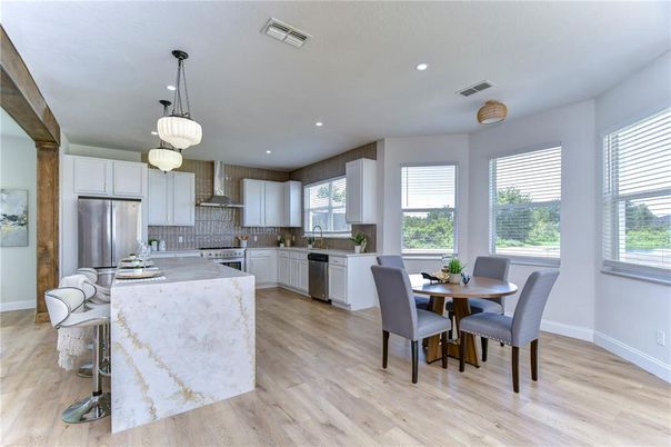 Dining room, Interior, Kitchen, Pendant Lights, Recessed Lighting, Stainless Steel Appliances, Wood Texture Flooring