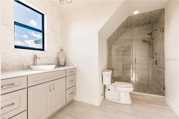 Bathroom, Glass Shower, Interior, Marble, Marble Walls, Recessed Lighting, Wood Texture Flooring