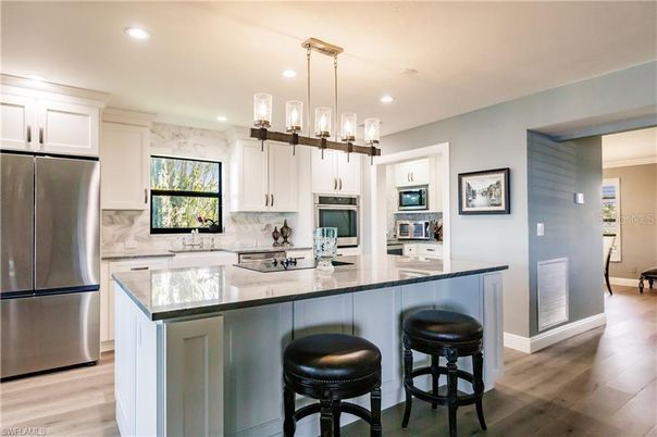 Interior, Kitchen, Marble Walls, Pendant Lights, Recessed Lighting, Stainless Steel Appliances, Wood Texture Flooring