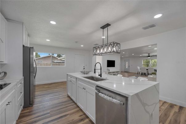 Dining room, Interior, Kitchen, Pendant Lights, Recessed Lighting, Stainless Steel Appliances, Wood Texture Flooring