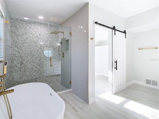 Bathroom, Free Standing Baths, Glass Shower, Interior, Marble Walls, Recessed Lighting, Wood Texture Flooring