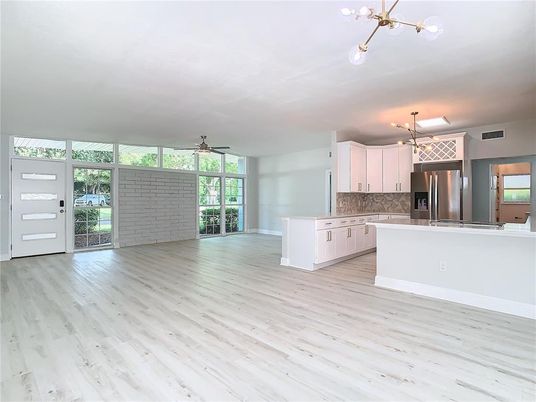 Empty room, Interior, Kitchen, Pendant Lights, Stainless Steel Appliances, Stone Walls, Wood Texture Flooring