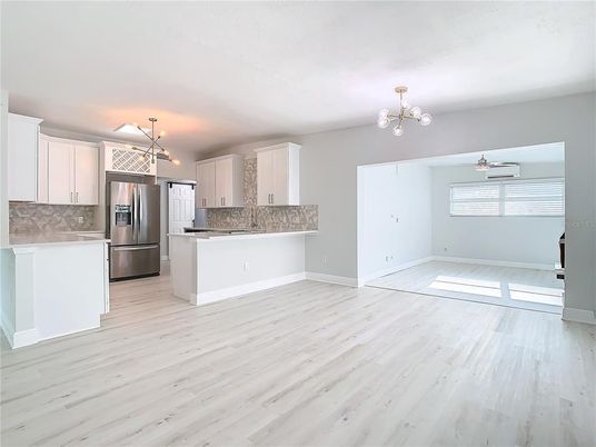 Empty room, Interior, Kitchen, Pendant Lights, Stainless Steel Appliances, Wood Texture Flooring