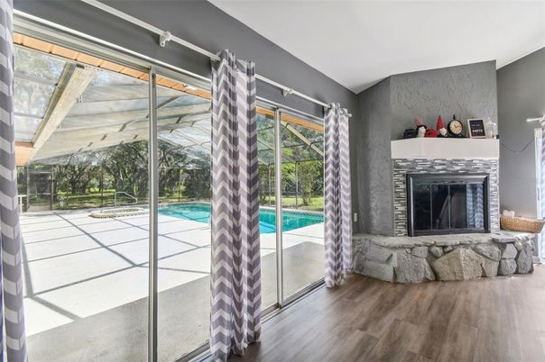 Fireplace, Glass Ceilings, Interior, Pool, Sun Room, Wood Texture Flooring