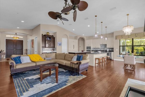 Chandelier, Interior, Kitchen, Living room, Pendant Lights, Recessed Lighting, Stainless Steel Appliances, Wood Texture Flooring