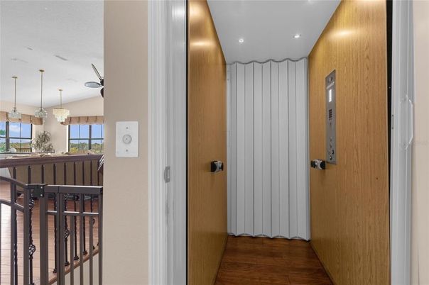 Elevator, Interior, Pendant Lights, Recessed Lighting, Wood Texture Flooring, Wooden Walls