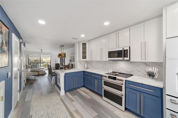 Dining room, Interior, Kitchen, Marble Walls, Pendant Lights, Recessed Lighting, Stainless Steel Appliances, Wood Texture Flooring