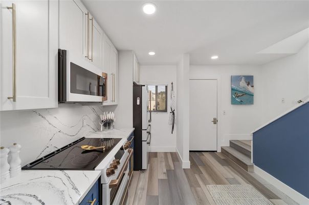 Fireplace, Interior, Kitchen, Marble Walls, Recessed Lighting, Wood Texture Flooring