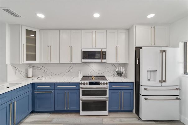 Interior, Kitchen, Marble Walls, Recessed Lighting, Stainless Steel Appliances, Wood Texture Flooring