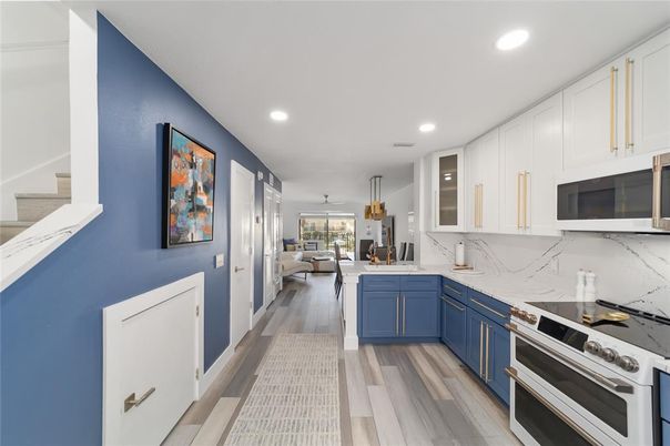Dining room, Interior, Kitchen, Marble Walls, Pendant Lights, Recessed Lighting, Stainless Steel Appliances, Wood Texture Flooring