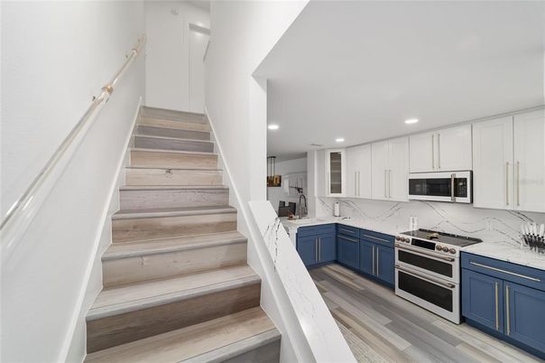 Interior, Kitchen, Marble Walls, Recessed Lighting, Stainless Steel Appliances, Wood Texture Flooring