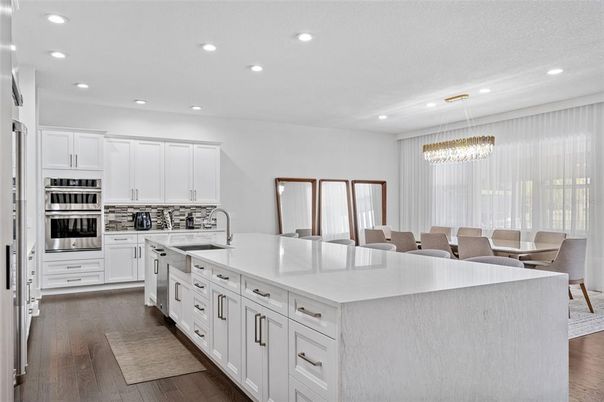 Chandelier, Dining room, Interior, Kitchen, Pendant Lights, Recessed Lighting, Stainless Steel Appliances, Wood Texture Flooring