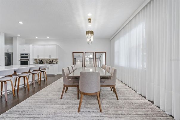 Chandelier, Dining room, Interior, Kitchen, Recessed Lighting, Stainless Steel Appliances, Wood Texture Flooring