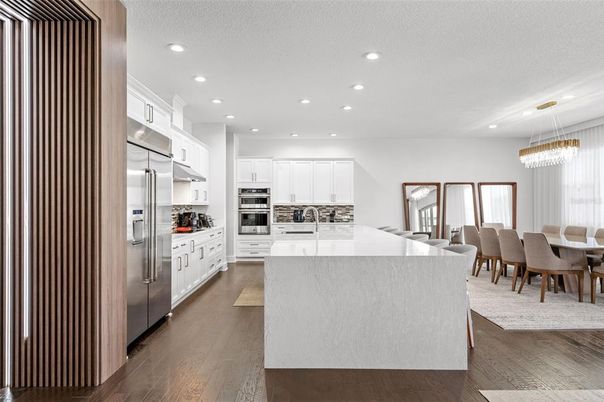 Chandelier, Dining room, Interior, Kitchen, Pendant Lights, Recessed Lighting, Stainless Steel Appliances, Wood Texture Flooring