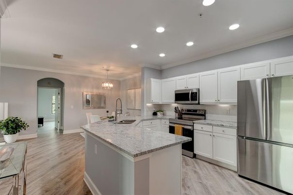 Chandelier, Dining room, Interior, Kitchen, Pendant Lights, Recessed Lighting, Stainless Steel Appliances, Wood Texture Flooring