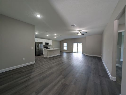 Empty room, Interior, Kitchen, Recessed Lighting, Stainless Steel Appliances, Wood Texture Flooring