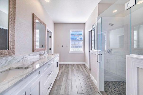 Bathroom, Dual Sink Vanities, Glass Shower, Interior, Recessed Lighting, Wood Texture Flooring