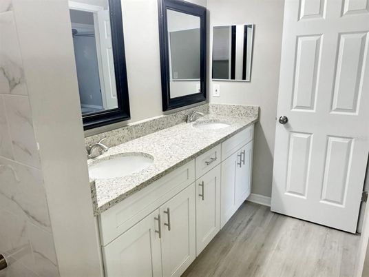 Bathroom, Dual Sink Vanities, Interior, Marble Walls, Wood Texture Flooring