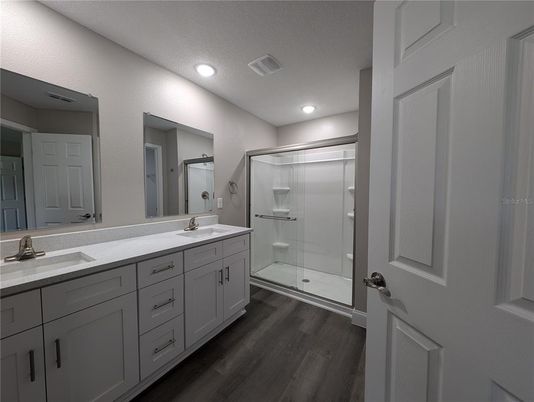 Bathroom, Dual Sink Vanities, Glass Shower, Interior, Recessed Lighting, Wood Texture Flooring