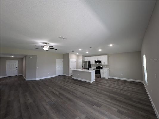Empty room, Interior, Kitchen, Recessed Lighting, Stainless Steel Appliances, Wood Texture Flooring