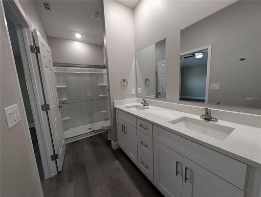 Bathroom, Dual Sink Vanities, Glass Shower, Interior, Recessed Lighting, Wood Texture Flooring