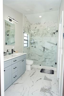Bathroom, Dual Sink Vanities, Glass Shower, Interior, Marble, Marble Walls, Recessed Lighting
