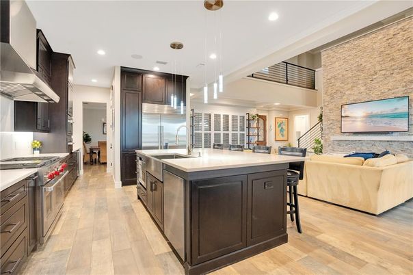 Interior, Kitchen, Living room, Pendant Lights, Recessed Lighting, Stainless Steel Appliances, Stone Walls, Wood Texture Flooring