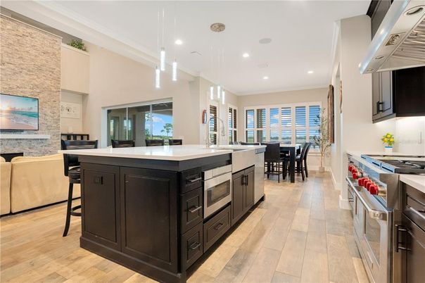 Dining room, Interior, Kitchen, Living room, Pendant Lights, Recessed Lighting, Stainless Steel Appliances, Stone Walls, Wood Texture Flooring