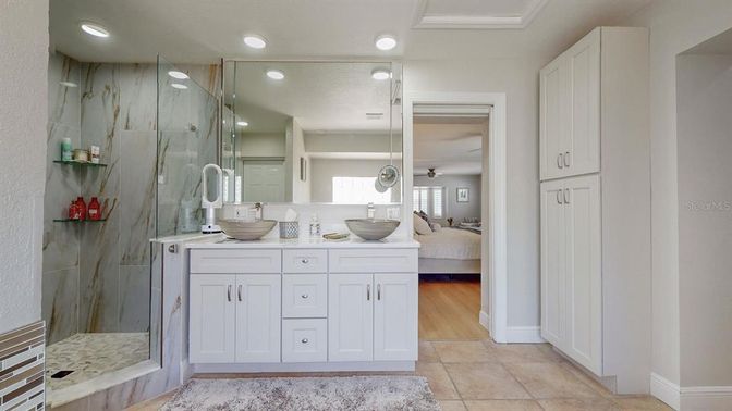 Bathroom, Dual Sink Vanities, Glass Shower, Interior, Marble Walls, Recessed Lighting, Wood Texture Flooring