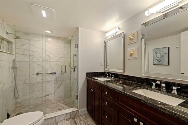 Bathroom, Dual Sink Vanities, Glass Shower, Interior, Marble, Marble Walls, Recessed Lighting