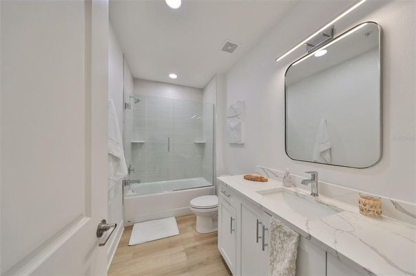 Bathroom, Dual Sink Vanities, Glass Shower, Interior, Recessed Lighting, Wood Texture Flooring
