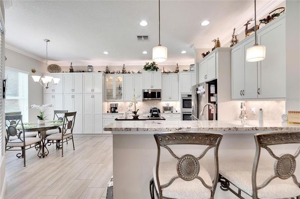 Chandelier, Dining room, Interior, Kitchen, Pendant Lights, Recessed Lighting, Stainless Steel Appliances, Wood Texture Flooring
