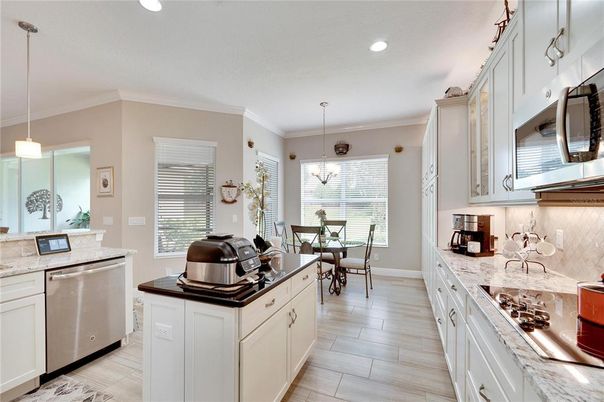 Chandelier, Dining room, Interior, Kitchen, Pendant Lights, Recessed Lighting, Stainless Steel Appliances, Wood Texture Flooring