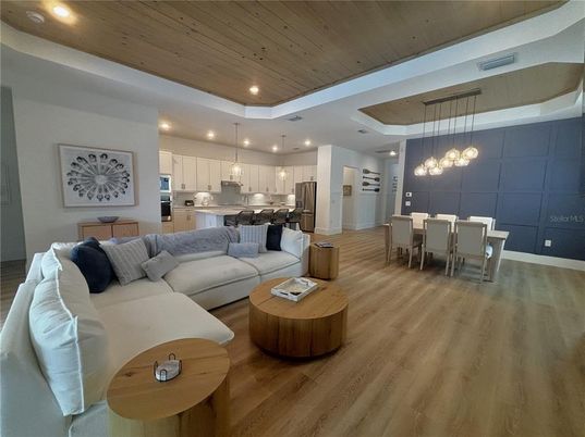 Dining room, Interior, Kitchen, Living room, Pendant Lights, Recessed Lighting, Stainless Steel Appliances, Wooden Ceilings, Wood Texture Flooring