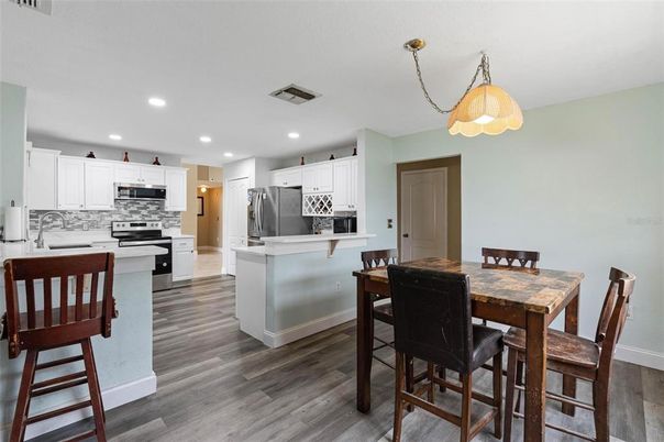 Dining room, Interior, Kitchen, Pendant Lights, Recessed Lighting, Stainless Steel Appliances, Wood Texture Flooring