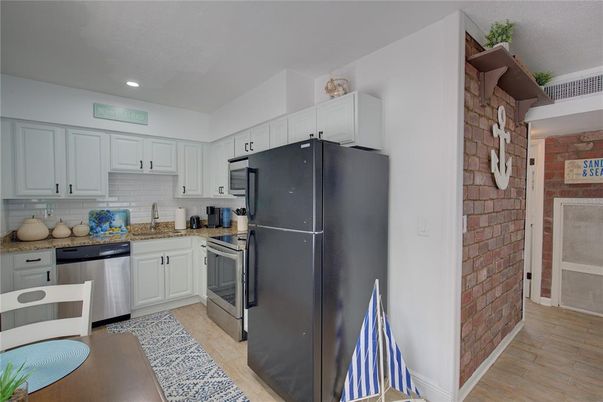 Interior, Kitchen, Recessed Lighting, Stainless Steel Appliances, Stone Walls, Wood Texture Flooring
