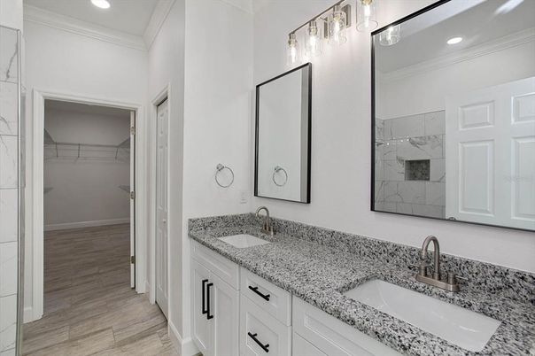 Bathroom, Dual Sink Vanities, Interior, Marble Walls, Recessed Lighting, Walk-in Closets, Wood Texture Flooring