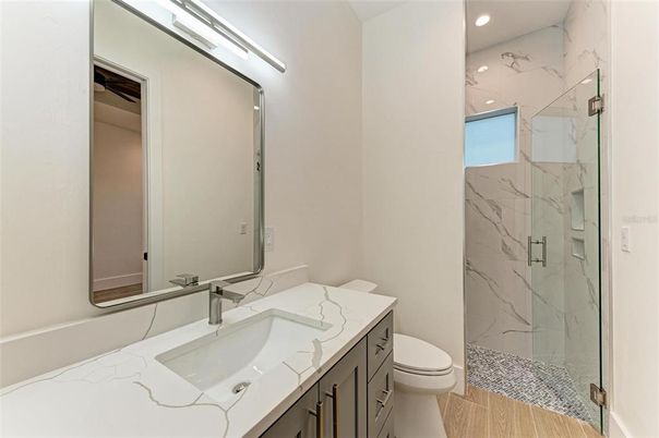 Bathroom, Glass Shower, Interior, Marble Walls, Recessed Lighting, Wood Texture Flooring