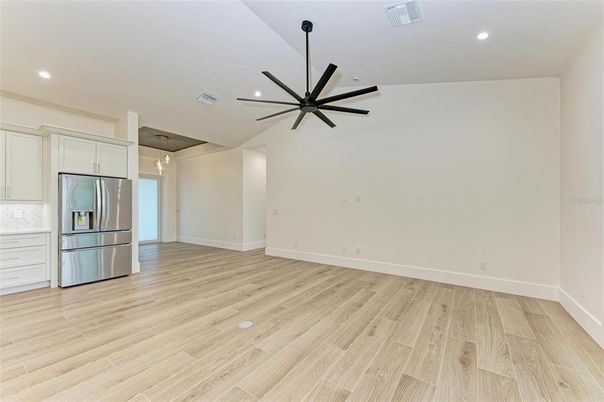 Empty room, Interior, Kitchen, Pendant Lights, Recessed Lighting, Stainless Steel Appliances, Wood Texture Flooring