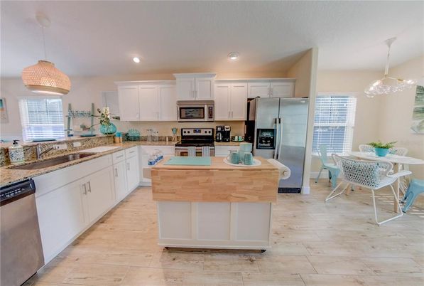 Dining room, Interior, Kitchen, Pendant Lights, Recessed Lighting, Stainless Steel Appliances, Wood Texture Flooring