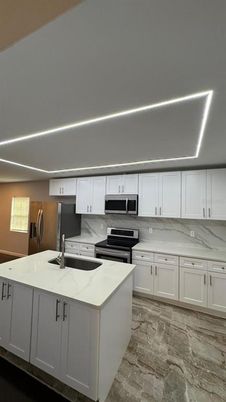 Interior, Kitchen, Marble Walls, Recessed Lighting, Stainless Steel Appliances